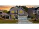 Charming two-story home showcasing a well-manicured lawn and attached two-car garage at 211 Saxony Loop, Summerville, SC 29486