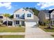 Charming two-story home showcasing a well-manicured lawn and attached two-car garage at 211 Saxony Loop, Summerville, SC 29486