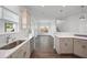 Bright kitchen view open to the adjacent room featuring wood floors, white cabinets and stainless steel appliances at 211 Saxony Loop, Summerville, SC 29486