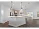 Modern kitchen with a large island, stainless steel appliances, and stylish pendant lighting at 211 Saxony Loop, Summerville, SC 29486