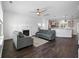 Open concept living room featuring fireplace, ceiling fan and wood flooring connected to a modern kitchen at 211 Saxony Loop, Summerville, SC 29486