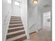 Carpeted staircase leading to an upper hallway and sunlit room featuring a ceiling fan at 211 Saxony Loop, Summerville, SC 29486