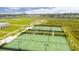 Aerial view of tennis courts lined with netting and lush green landscaping at 211 Saxony Loop, Summerville, SC 29486
