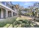Spacious backyard featuring a lawn, mature trees, and a black metal fence for privacy and security at 2292 Beckenham Dr, Mount Pleasant, SC 29466
