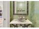 Powder room with a unique glass vessel sink, decorative mirror and modern plumbing fixtures at 2292 Beckenham Dr, Mount Pleasant, SC 29466
