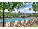 Resort-style community pool with ample lounge chairs, umbrellas, and shaded pavilion, surrounded by palm trees at 2292 Beckenham Dr, Mount Pleasant, SC 29466