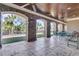 Relaxing covered patio featuring brick columns, stone flooring, and views of the landscaped yard at 2292 Beckenham Dr, Mount Pleasant, SC 29466