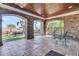 Inviting covered patio with brick arches, stone flooring, and outdoor seating overlooking lush scenery at 2292 Beckenham Dr, Mount Pleasant, SC 29466