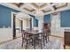 Elegant dining room featuring a decorative chandelier, coffered ceiling, and large windows with plantation shutters at 2292 Beckenham Dr, Mount Pleasant, SC 29466