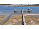 Picturesque view of a wooden dock extending into the waterway, surrounded by lush marshland and tranquil waters at 2292 Beckenham Dr, Mount Pleasant, SC 29466