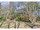Exterior view of an elegant home with mature landscaping, steps, and a lush lawn at 2292 Beckenham Dr, Mount Pleasant, SC 29466