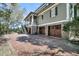 Spacious three-car garage and upper porch of an elegant home with brick driveway at 2292 Beckenham Dr, Mount Pleasant, SC 29466