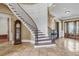 Elegant foyer showcasing a curved staircase, hardwood treads, and a decorative grandfather clock at 2292 Beckenham Dr, Mount Pleasant, SC 29466