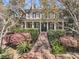 Charming two-story home with a manicured lawn and a grand staircase leading to a welcoming front porch at 2292 Beckenham Dr, Mount Pleasant, SC 29466