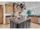 Kitchen with a stone hood, granite countertops, a pot rack and custom cabinets in a luxury home at 2292 Beckenham Dr, Mount Pleasant, SC 29466