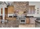 Custom kitchen features stone range hood, granite counters, stainless steel Wolf range and custom wood cabinets at 2292 Beckenham Dr, Mount Pleasant, SC 29466