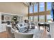 Bright living room featuring soaring ceilings, a piano, large windows, and elegant, comfortable seating at 2292 Beckenham Dr, Mount Pleasant, SC 29466