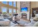 Cozy living room with a stone fireplace, large windows, and comfortable seating at 2292 Beckenham Dr, Mount Pleasant, SC 29466