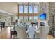 Inviting living room with soaring ceilings, a stone fireplace, and large windows offering scenic views at 2292 Beckenham Dr, Mount Pleasant, SC 29466