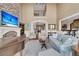 Elegant living room boasts a stone fireplace, soaring ceilings, and open access to other living spaces at 2292 Beckenham Dr, Mount Pleasant, SC 29466