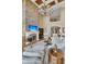 Living room features a stone fireplace, balcony, and large chandelier in this elegantly designed home at 2292 Beckenham Dr, Mount Pleasant, SC 29466