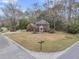 Aerial view of a two-story brick home with a large, well-maintained front lawn and surrounding mature trees at 235 Scalybark Rd, Summerville, SC 29485