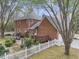 Spacious backyard featuring a brick home with a large patio and a charming white picket fence at 235 Scalybark Rd, Summerville, SC 29485