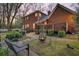 Inviting backyard with lush greenery, fire pit, and brick patio perfect for outdoor entertaining at 235 Scalybark Rd, Summerville, SC 29485