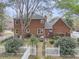 Large brick home with a well-maintained backyard, white picket fence and garden at 235 Scalybark Rd, Summerville, SC 29485