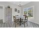 Eat-in kitchen features a modern chandelier, black and white patterned flooring, and natural light at 235 Scalybark Rd, Summerville, SC 29485