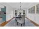Open dining room offers natural light, modern light fixture, wainscoting, and neutral color palette at 235 Scalybark Rd, Summerville, SC 29485