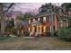 Classic brick residence featuring a covered front entrance, dark shutters, and mature trees, enhancing its curb appeal at 235 Scalybark Rd, Summerville, SC 29485