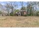 Lovely brick home featuring a covered front porch, framed by trees and a spacious front lawn at 235 Scalybark Rd, Summerville, SC 29485