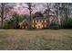 Charming two-story brick home featuring a covered front porch with white columns and a beautifully manicured lawn at 235 Scalybark Rd, Summerville, SC 29485