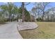 Long driveway leading to a beautiful brick home with mature trees and landscaping at 235 Scalybark Rd, Summerville, SC 29485