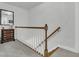 Upstairs hallway with wood railing and carpeting leads to the upper-level rooms at 235 Scalybark Rd, Summerville, SC 29485