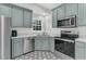 Bright kitchen features gray cabinetry, stainless steel appliances, and unique black and white patterned flooring at 235 Scalybark Rd, Summerville, SC 29485