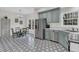 Spacious kitchen with stainless steel appliances, an eat-in area with chandelier, and eye-catching patterned floor at 235 Scalybark Rd, Summerville, SC 29485