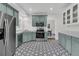 Updated kitchen showcasing stainless steel appliances, unique flooring, and ample countertop space at 235 Scalybark Rd, Summerville, SC 29485