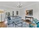 Bright living room showcases hardwood floors, a modern chandelier, and comfortable seating at 235 Scalybark Rd, Summerville, SC 29485
