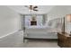 Bright main bedroom featuring a ceiling fan, windows, and dresser at 235 Scalybark Rd, Summerville, SC 29485