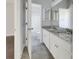 Bright bathroom with gray tile floors, double granite vanity, and tub shower at 253 Palmetto Walk Dr, Summerville, SC 29486