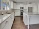 Bright kitchen featuring white cabinets, granite countertops, stainless steel appliances, and a kitchen island at 253 Palmetto Walk Dr, Summerville, SC 29486