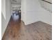 Open-concept living space features hardwood floors, access to a kitchen, and an adjacent staircase at 253 Palmetto Walk Dr, Summerville, SC 29486