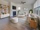 Bright living room features a fireplace, ceiling fan, hardwood floors, and a neutral color palette at 253 Palmetto Walk Dr, Summerville, SC 29486