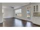 A spacious living room with white walls, hardwood floors, and access to the backyard patio at 253 Palmetto Walk Dr, Summerville, SC 29486