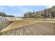 Expansive backyard with a wood fence and a beautiful water view provides ample space for recreation and relaxation at 259 N Light Way, Summerville, SC 29486