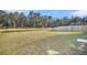 Well-maintained backyard features a wooden fence and views of the serene water, blending privacy with scenic beauty at 259 N Light Way, Summerville, SC 29486