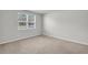 The carpeted bedroom has neutral walls and a window with natural light at 259 N Light Way, Summerville, SC 29486