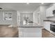 Bright, open kitchen island features granite countertops and a stainless steel sink at 259 N Light Way, Summerville, SC 29486